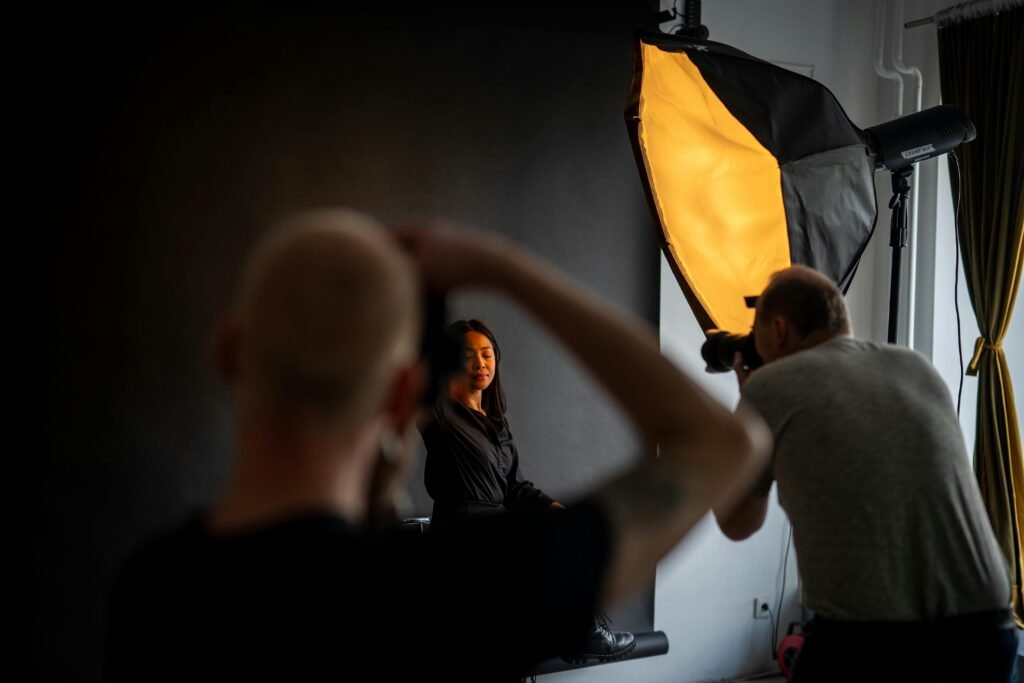 A photographer captures a model in a Berlin studio setting with professional lighting equipment.